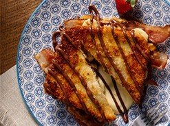 Crispy french toast sandwich with bacon, chocolate and custard